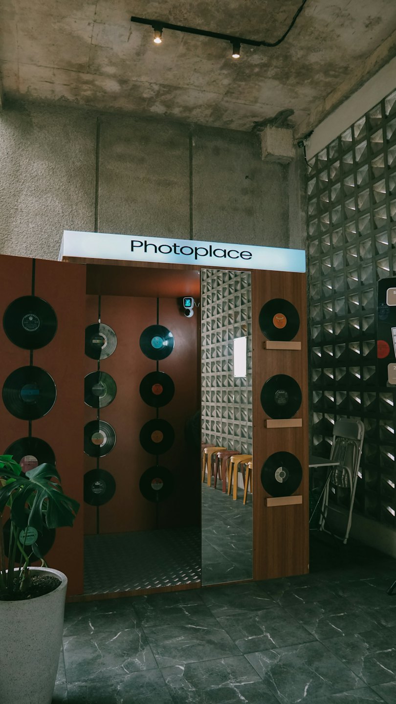 Photoplace booth entrance decorated with vinyl records and wooden accents.